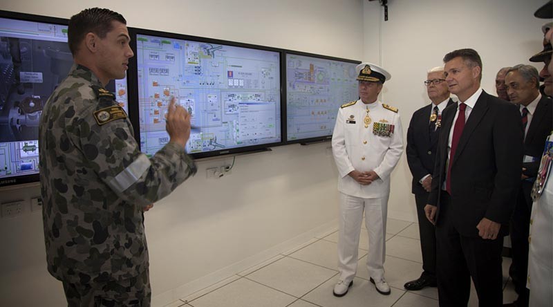 Leading Seaman Maritime Technician Nathan Cook briefs Chief of Navy, Vice Admiral Tim Barrett and the Matt Thistlethwaite MP. Photo by Able Seaman Bonnie Gassner.