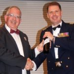 Guest speaker Group Captain Richard Trotman-Dickenson, Officer Commanding Information Warfare Wing at RAAF Base Edinburgh receives a token of appreciation from emcee Pilot Officer (AAFC) Paul Rosenzweig.