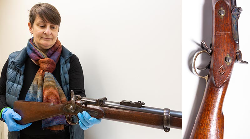 Corinne Ball, Curator History Trust of South Australia, inspects the 1868 Braendlin-Albini rifle. Photo by Leading Aircraftwoman Jacqueline Forrester.
