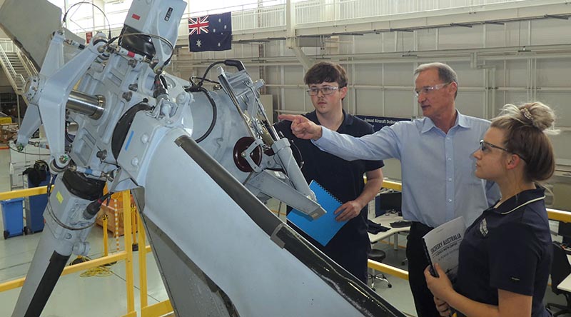 Sikorsky Australia’s apprentice aircraft maintenance engineer students Corey Plummer (left) and Nicola Douet receive instruction from Tony Intihar as during their aircraft maintenance training at Sikorsky Australia. Image supplied.