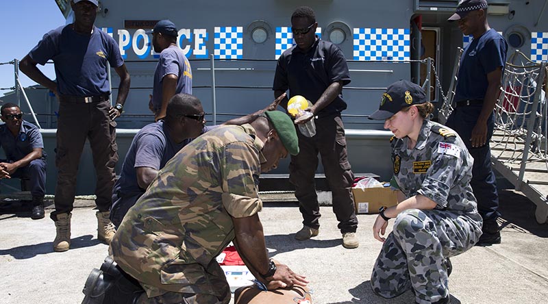 Royal Australian Navy Lieutenant Rhianna Jones teaches CPR to police officers from the Vanuatu Police Force Maritime Wing and Vanuatu Mobile Ground Forces soldiers in Port Villa, Vanuatu. Photo by Sergeant Ray Vance.