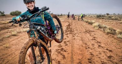 Flying Officer Kaylee Verrier carries her bike through some muddy terrain during the adventure-networking expedition. Story and photo by Corporal Melina Young.