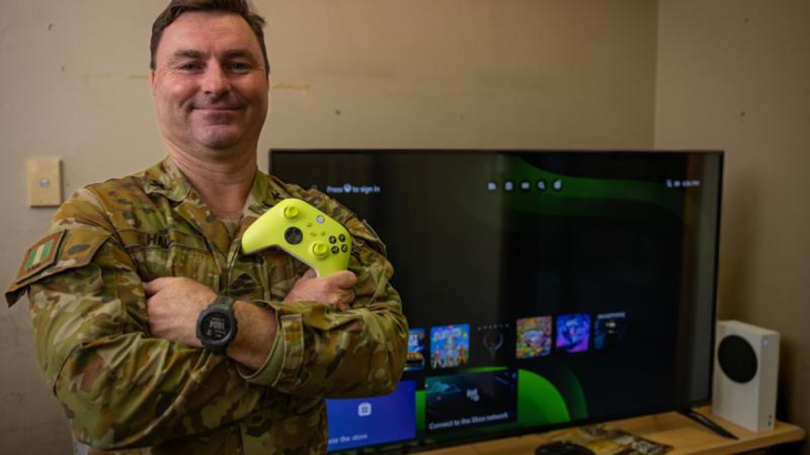 Army Chaplain James Hall, of 6th Battalion, the Royal Australia Regiment, in the unit's social gaming hub at Gallipoli Barracks, with equipment donated by Veteran Gaming Australia. Story and photo by Corporal Michael Rogers.