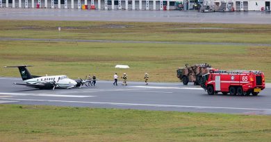 Royal Australian Air Force aviators from No. 26 Squadron provide assistance to occupants disembarking Beechcraft B200 Super King Air VH-XDV after an emergency wheels-up landing at Newcastle Airport, NSW. Photo by Leading Aircraftman Kurt Lewis.