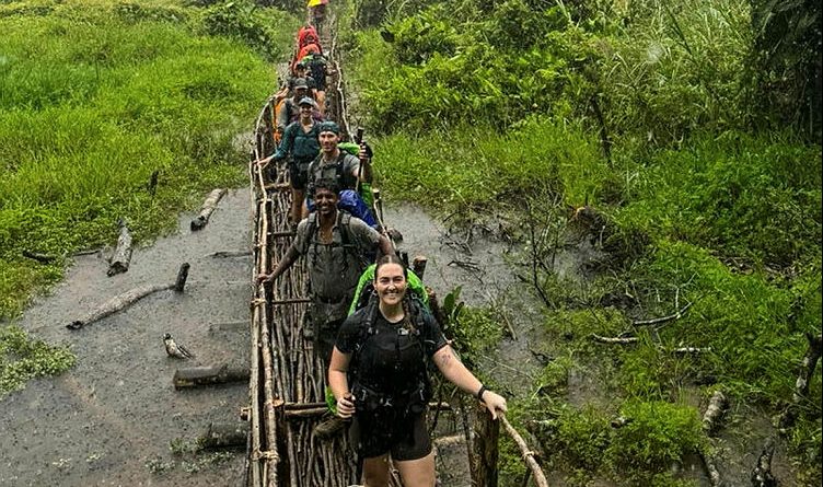 HMAS Cairns sailors cross a swamp marsh on their way to Agulogo on day three along the Kokoda Track. Story by Corporal Melina Young.