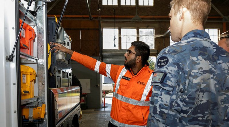 Saurabh Sibal, assistant project officer for NSW SES, shows Flying Officer Phillip Davies equipment loaded onto an SES vehicle during Exercise Cannonball at RAAF Base Richmond. Story by Flying Officer Madeleine Magee. Photos by Sergeant Dan Pinhorn.