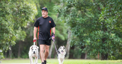 Laurie Wallace walks his family dogs Patch and Zelda around their north Brisbane suburb. Story by Major Evita Ryan. Photo by Lance Corporal Luke Donegan.