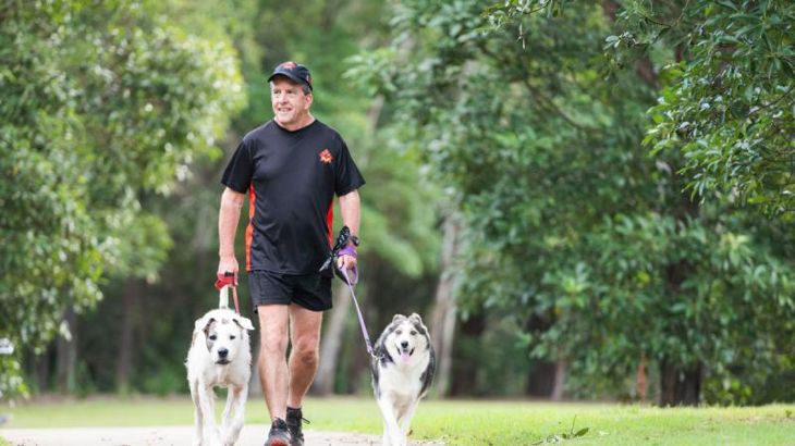 Laurie Wallace walks his family dogs Patch and Zelda around their north Brisbane suburb. Story by Major Evita Ryan. Photo by Lance Corporal Luke Donegan.