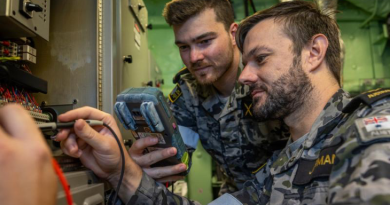 Electronics technicians Able Seaman William Clayton, left, and Leading Seaman Matthew Jarman inspect a component in a radar room following a damage control scenario aboard HMAS Adelaide. Story and photo by Corporal Jacob Joseph.