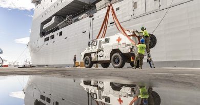 A Bushmaster protected mobility vehicle bound for the Republic of Fiji Military Forces is loaded onto HMAS Choules in Brisbane, Queensland. Photo by Able Seaman Lucinda Allanson.