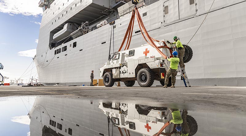 A Bushmaster protected mobility vehicle bound for the Republic of Fiji Military Forces is loaded onto HMAS Choules in Brisbane, Queensland. Photo by Able Seaman Lucinda Allanson.