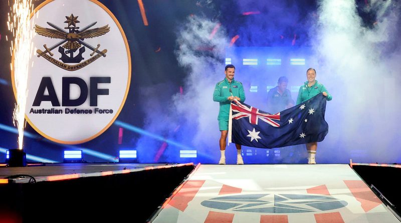 Team Australia captains Sergeant Emily Lahey, right, and Cooper Blackwood carry the Australian National Flag as they lead the Australian contingent competing at the Warrior Games 2024 on to the stage for the closing ceremony. Story by Flying Officer Belinda Barker. Photos by Flight Sergeant Christopher Dickson.