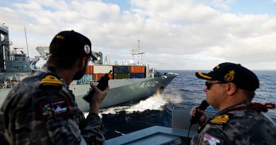 Lieutenant Nicholas Dale, left, and Commanding Officer HMAS Sydney Commander Billy Maddison steer the ship during a replenishment at sea with German Navy Ship Frankfurt Am Main during Exercise Rim of the Pacific 2024. Story by Lieutenant Tahlia Merigan. Photos bu Leading Seaman Daniel Goodman.
