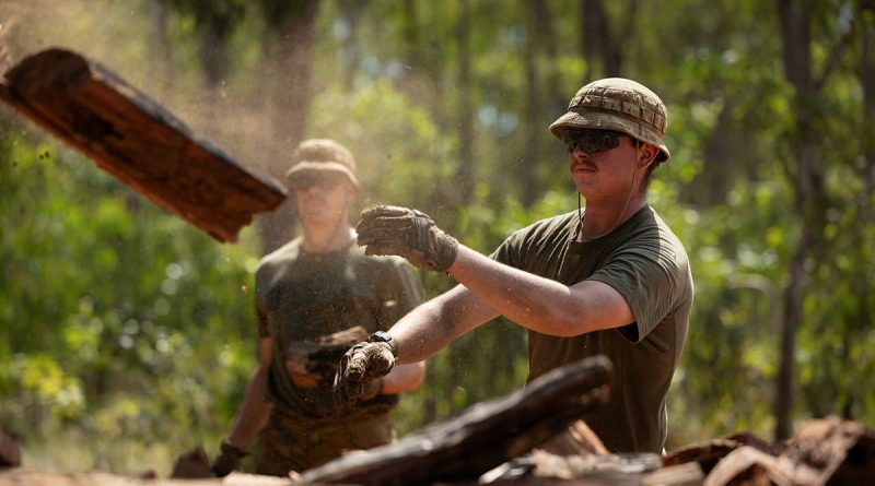 Sapper Jack Henderson, from 1st Combat Engineer Regiment, throws wood on a pile for the Garma Festival during Exercise Predator's Run in Nhulunbuy, NT. Story and photos by Corporal Jacob Joseph.