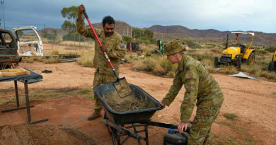 Private Luke Kennedy and Captain Debra Johnson mix cement to create tiles for the Amata Anangu School in remote north-western South Australia. Story by Major Evita Ryan. Photo by Corporal Michael Cassidy.