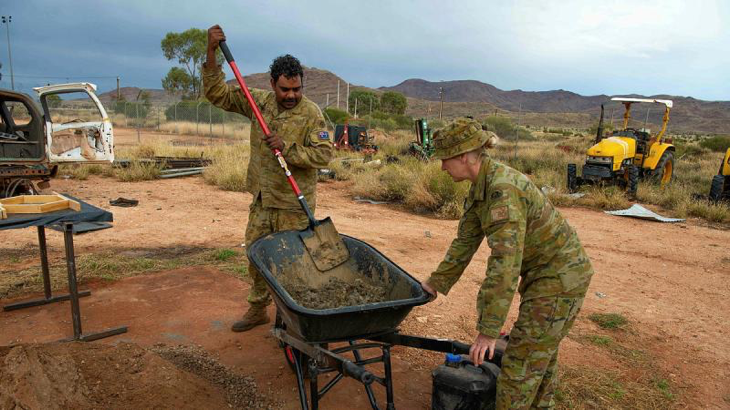 Private Luke Kennedy and Captain Debra Johnson mix cement to create tiles for the Amata Anangu School in remote north-western South Australia. Story by Major Evita Ryan. Photo by Corporal Michael Cassidy.