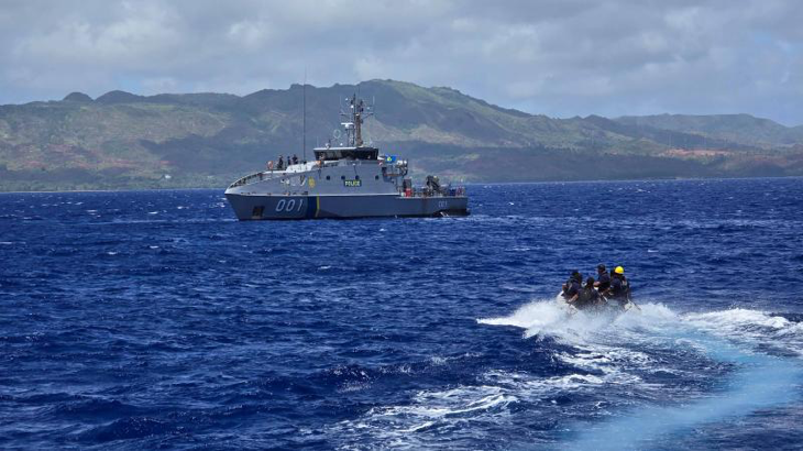 A Republic of the Marshall Islands team from the Pacific Forum-class RMIS Lomor approaches the Guardian-class patrol ships PSS President HI Remeliik II from the Republic of Palau to run through a mock law enforcement boarding off Guam. Story by Leon Ha. Photo by Chief Petty Officer Aaron Wheeler.
