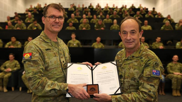 Deputy Chief of Army Major General Christopher Smith, left, presents Warrant Officer Class 1 Rodney Speter with his two Federation Stars for 45 years of service. Story and photos by Warrant Officer Class 2 Andrew Hetherington.