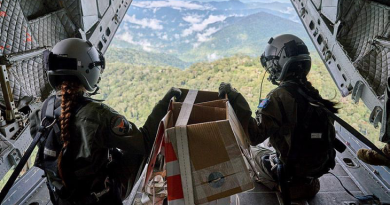 Corporal Monique Jeynes and Corporal Amanda Wintle on the ramp of a RAAF C-27J Spartan prepare to airdrop supplies over the Kokoda Track, Papua New Guinea, as part of the Defence Pacific Air Program.