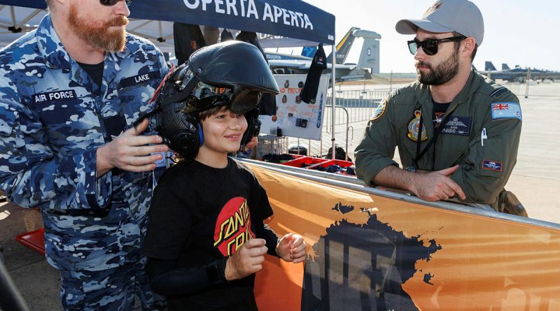 Angus, from the Starlight Children’s Foundation, tries on an F-35A helmet with the help of Corporal Daniel Lake, a 3 Squadron life support fitter, at the Pitch Black open day at RAAF Base Darwin. Story by Flying Officer Jamie Wallace. Photos by Sergeant David Gibbs.