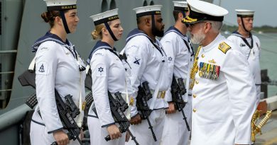 Commander Australian Fleet Rear Admiral Chris Smith speaks to a member of HMAS Melville's ceremonial guard during the ship’s decommissioning ceremony at Trinity Wharf in Cairns. Story by Lieutenant Commander Anthony Martin. Photos by Petty Officer Leo Baumgartner.