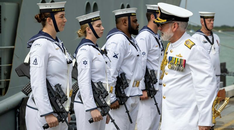 Commander Australian Fleet Rear Admiral Chris Smith speaks to a member of HMAS Melville's ceremonial guard during the ship’s decommissioning ceremony at Trinity Wharf in Cairns. Story by Lieutenant Commander Anthony Martin. Photos by Petty Officer Leo Baumgartner.