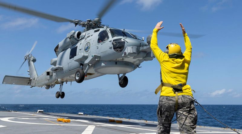 Leading Seaman Aviation Technician Airframe Prudence Harper, of 808 Squadron, conducts a flying exercise with HMAS Perth’s MH-60R aircraft 'Siren' during a regional presence deployment. Story by Lieutenant Commander Andrew Herring. Photos by Leading Seaman Ernesto Sanchez.