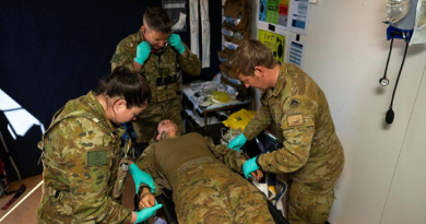 Corporal Timothy Rymill, right, and other Army medical personnel from 1st Health Battalion triage a simulated patient inside the Role 1 treatment facility at RAAF Base Curtin, WA, during Exercise Austral Shield. Story by Captain Diana Jennings. Photos by Corporal Lisa Sherman.