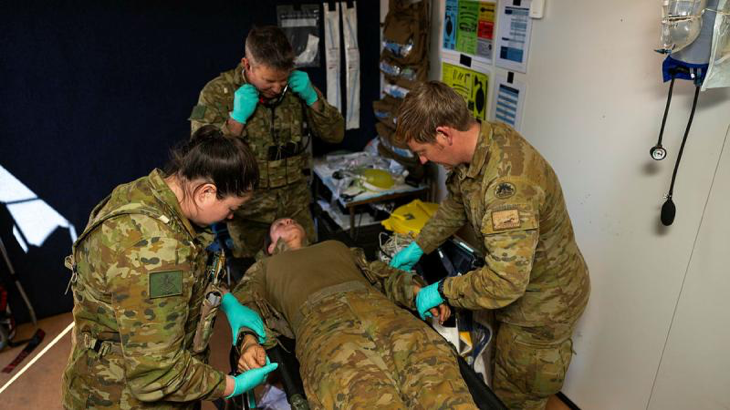 Corporal Timothy Rymill, right, and other Army medical personnel from 1st Health Battalion triage a simulated patient inside the Role 1 treatment facility at RAAF Base Curtin, WA, during Exercise Austral Shield. Story by Captain Diana Jennings. Photos by Corporal Lisa Sherman.