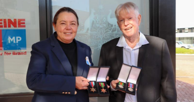 Madeleine King MP hands over Sergeant John Brislin’s WW2 medals to his son, Bruce Brislin, outside her office in Rockingham, WA. Story by Lieutenant Commander John . Photos Supplied.