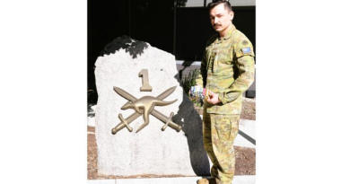 Army Captain Blake Parbery holds his grandfather Gordon Wells' service medals, outside Headquarters 1st (Australian) Division, Gallipoli Barracks, Enoggera, Queensland. Story and photo by Captain Peter Nugent.