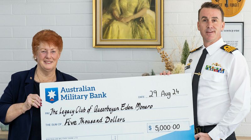 Commanding Officer HMAS Harman Commander Glyn Hunter presents Legacy Club of Queanbeyan-Eden-Monaro president Suzanne McInnes with a cheque during a morning tea at the Legacy Club of Queanbeyan-Eden-Monaro, NSW. Photos by Corporal Jacob Joseph.