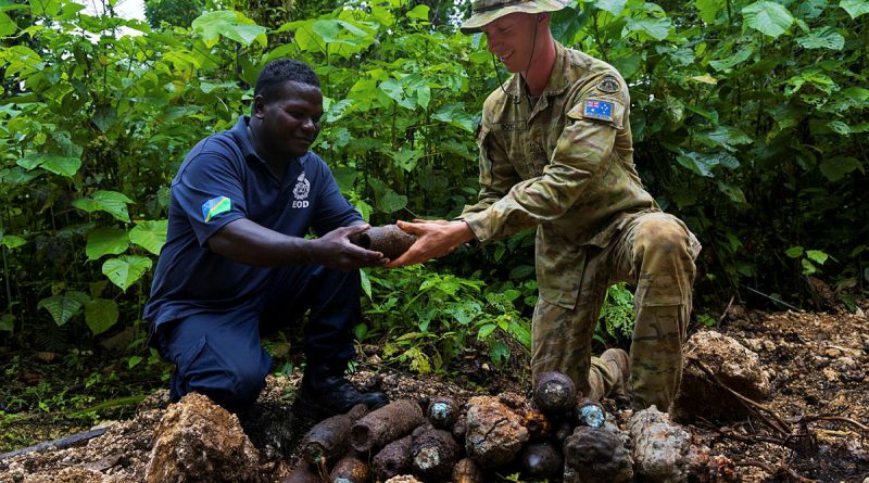 Australian Army Corporal Solomon Boyd and Royal Solomon Islands Police Force officer Tusa consolidate explosive remnants of war during Operation Render Safe, Munda, Solomon Islands. Story by Sergeant David Said. Photos by Corporal Sam Price.