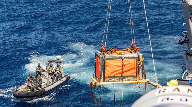 The stores dropped by the RAAF C-27J Spartan are craned onto HMAS Warramunga's deck during Exercise Kakadu 24. Story by Lieutenant Marie Davies. Photo by Midshipman Joshua Breedon.