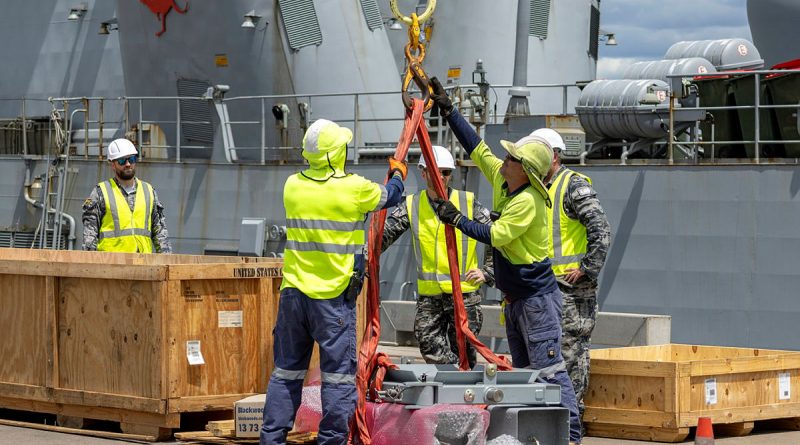 Support staff from Thales Australia, Port of Darwin and the ADF assist in the re-arming of HMAS Warramunga's vertical launching system in Darwin, NT. Story by Lieutenant Commander Jonathan White. Photos by Petty Officer Leo Baumgartner.