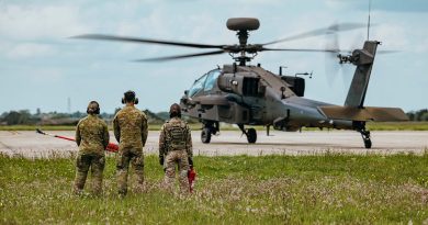 A British soldier from 3 Regiment Army Air Corps and soldiers from the 1st Aviation Regiment, Australian Army Aviation Command, observed as a AH-64E attack helicopter taxis down the pan during their learning experience at Wattisham Flying Station. Story by Major Lily Charles. Photos by Photos: Corporal Aaron J Stone.