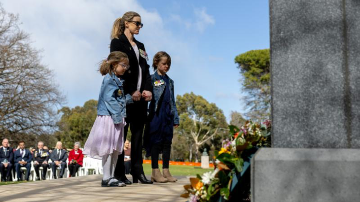 Major Angela Uphill and her two children lay a wreath during the 2024 Legacy Week launch at the Australian War Memorial, Canberra. Story by Corporal Luke Bellman. Photo by Leading Seaman Nadav Harel.