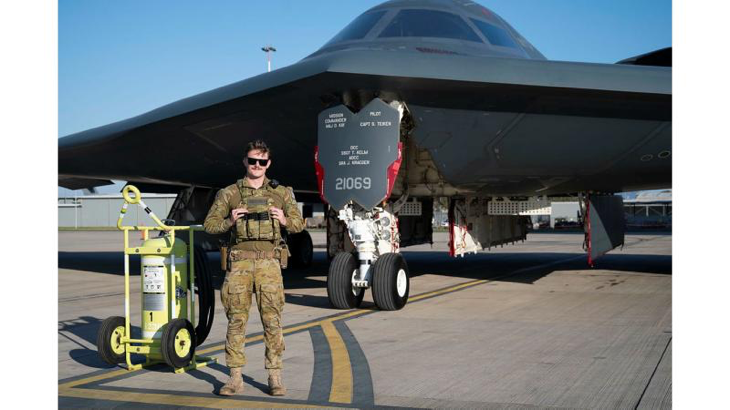 Leading Aircraftman Blake O'Brien stands in front of a US Air Force B-2 Spirit Stealth Bomber on the RAAF Base Amberley flight line. Story by Flight Lieutenant Rob Hodgson. Photo by US Air Force