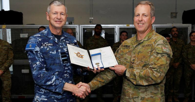 Air Commander Australia Air Vice-Marshal Glen Braz, left, awards Leading Aircraftman Samuel Conroy with a gold commendation at 1 Security Forces Squadron, RAAF Base Williamtown. Story by Flight Lieutenant Grace Casey-Maughan.