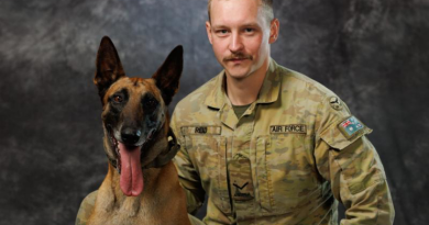 Air Force military working dog handler, Leading Aircraftman James Reid from 1 Security Forces Squadron, and retired military working dog Drak, at RAAF Base Williamtown. Story by Flight Lieutenant Grace Casey-Maughan. Photo byLeading Aircraftman Kurt Lewis.