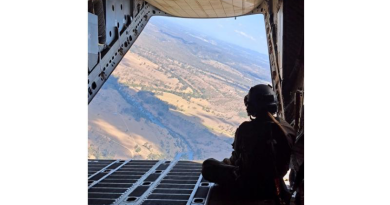 Air Force C-27J Spartan loadmaster Corporal Deniele Oehm enjoys the view on the ramp of a C-27J Spartan during a flight. Story by Flight Lieutenant Imogen Lunny.