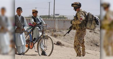 An Australian Army medic chats with students during a visit to a boys' school in southern Afghanistan. Photo by Corporal Ricky Fuller.