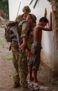 Australian soldiers with 3rd Battalion, Royal Australian Regiment, arrest a suspected militia member in the Oecusse Enclave, East Timor. Photo by Corporal Brian Hartigan.