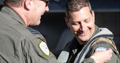 Squadron Leader Jason Gamlin, right, is presented with his 4000th Hornet hour patch by Officer Commanding 82 Wing, Group Captain Paul Jarvis, at RAAF Base Amberley. Story by Flight Lieutenant Greg Hinks. Photos by Leading Aircraftwoman Taylor Anderson.