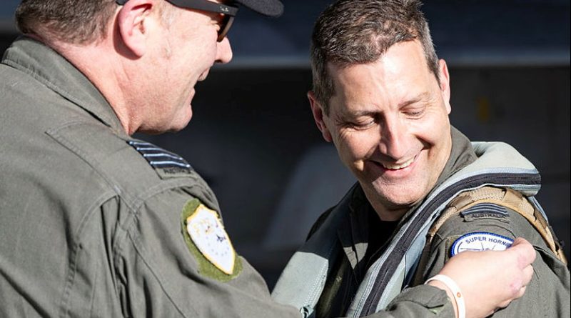 Squadron Leader Jason Gamlin, right, is presented with his 4000th Hornet hour patch by Officer Commanding 82 Wing, Group Captain Paul Jarvis, at RAAF Base Amberley. Story by Flight Lieutenant Greg Hinks. Photos by Leading Aircraftwoman Taylor Anderson.