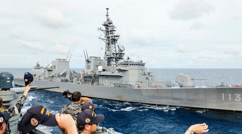 HMAS Sydney’s bridge team waves towards Japan Maritime Self-Defense Force ship JS Sazanami during a formation foxtrot as part of a regional presence deployment. Story by Lieutenant Tahlia Merigan. Photos by Leading Seaman Daniel Goodman.