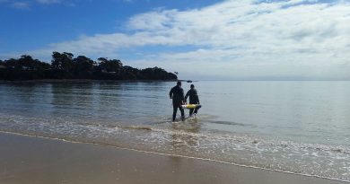 Students from Navy's Mine Warfare Faculty wade out in the water as part of training in Tasmania.