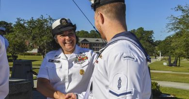 Master Chief Petty Officer Cynthia Huratiak, command master chief for the Naval Nuclear Power Training Command, congratulates an unnamed Royal Australian Navy sailor after his graduation from the United States Navy Nuclear Power School. US Navy photo by Kellie Randall.