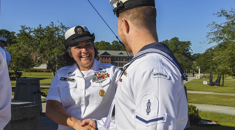 Master Chief Petty Officer Cynthia Huratiak, command master chief for the Naval Nuclear Power Training Command, congratulates an unnamed Royal Australian Navy sailor after his graduation from the United States Navy Nuclear Power School. US Navy photo by Kellie Randall.