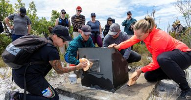 Members of Air Combat Electronic Attack Systems Program Office clean the memorial site for the lost aircrew of a downed F-111C during a team-building activity at Bundjalung National Park, Queensland. Story by Pilot Officer Timothy Sullivan. Photo by Leading Aircraftwoman Campbell Latch.